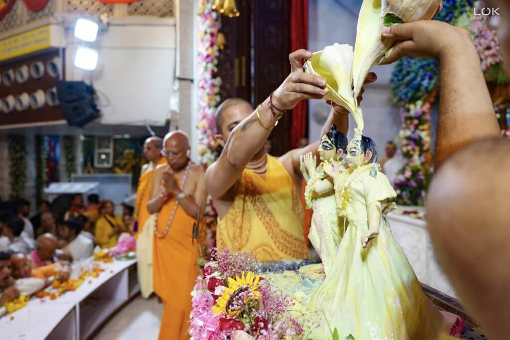 Pandit (Priest) performing abhishek on Krishna Janamashtami celebrations at ISKCON Noida Sector 33