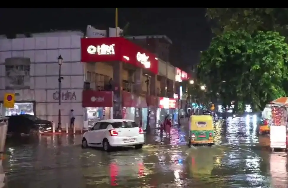 Waterlogged street in Noida during 2026 monsoon season with flooded road and traffic